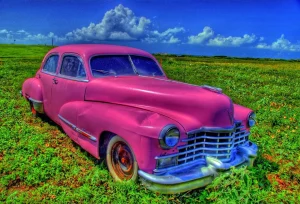 a pink car in a field